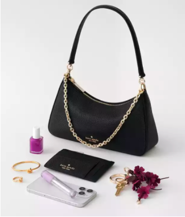 Black kate spade shoulder bag with gold chain, card case, jewelry, nail polish and flowers